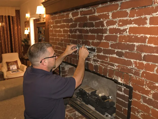 Long Beach Chimney Sweep expert fixing a fireplace in Long Beach, CA